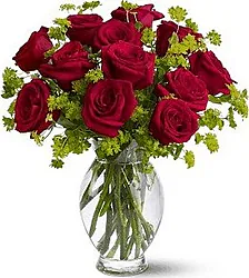 Bouquet of 12 Red Roses with seasonal greenery, a combination of elegance and freshness ideal for any special occasion.