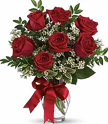 Bouquet of 7 large red roses with decorative greenery and elegant packaging. Ideal for expressing love and affection on any special occasion
