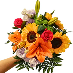 Bouquet of sunflowers and mixed flowers decorated with seasonal greenery. Brightens any occasion with its vibrant natural beauty.